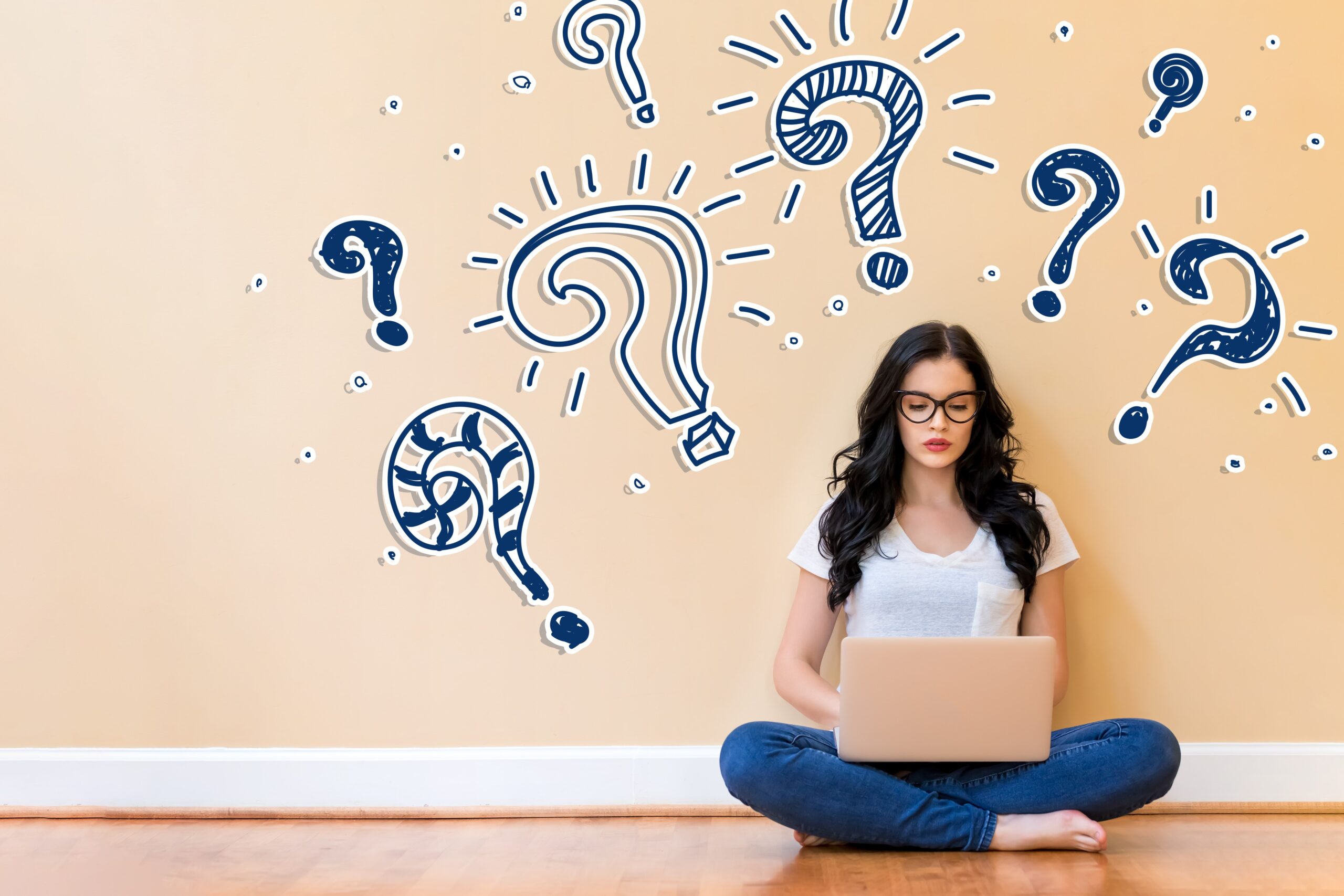 young bespectacled woman with laptop surrounded by question marks, claiming back tax concept