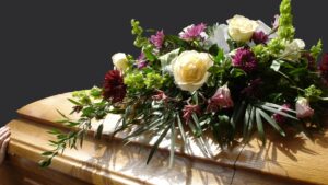 Funeral casket with flowers, bereavement leave concept