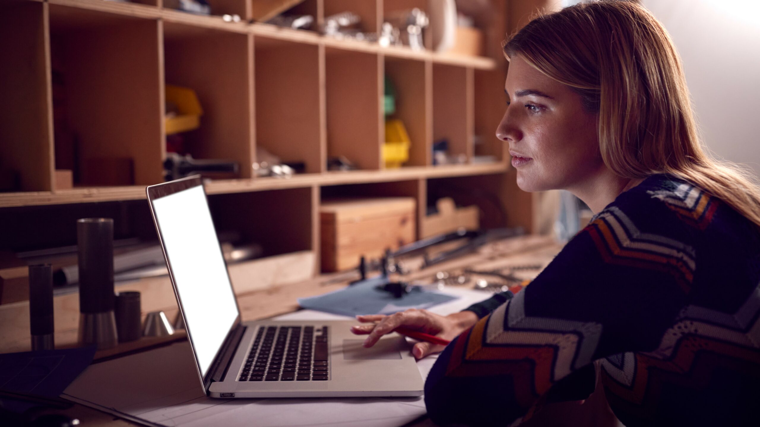 Young woman gazing at laptop, setting up sole trader concept