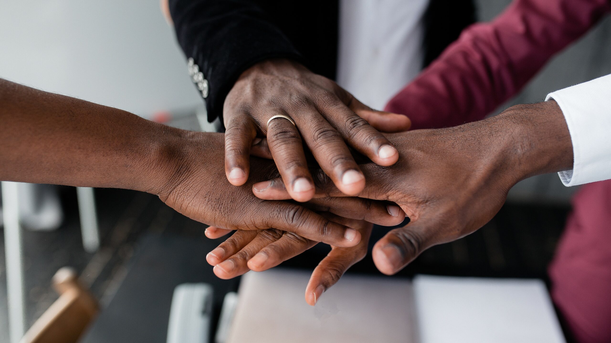 Black hands on top of each other, Equality Act concept