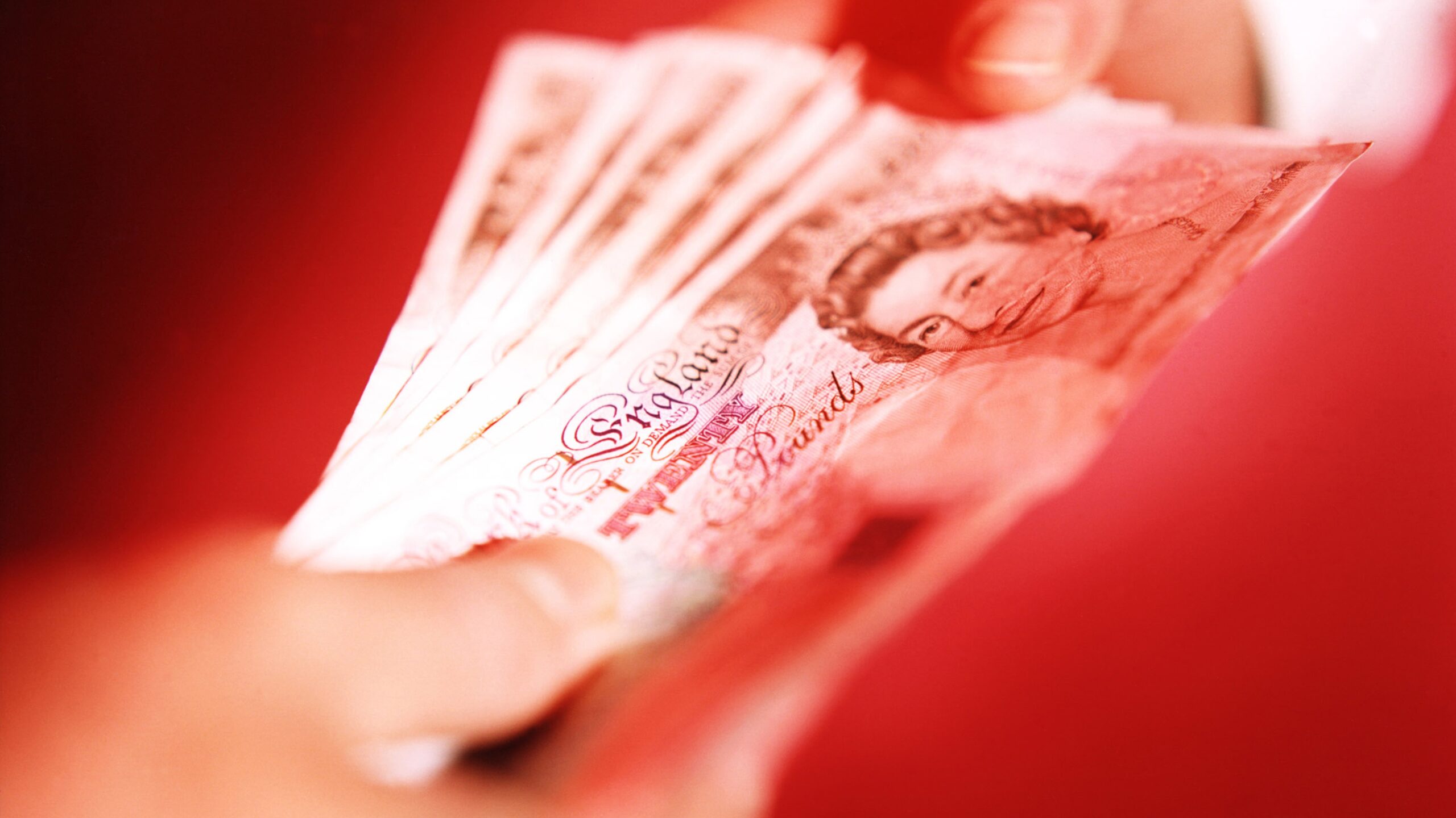 handing over £20 notes, second income concept