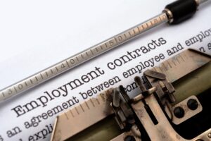'Employment contracts' typed on typewriter, employee contracts concept