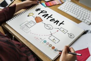 hands sketching out patent flow chart, obtain patent concept