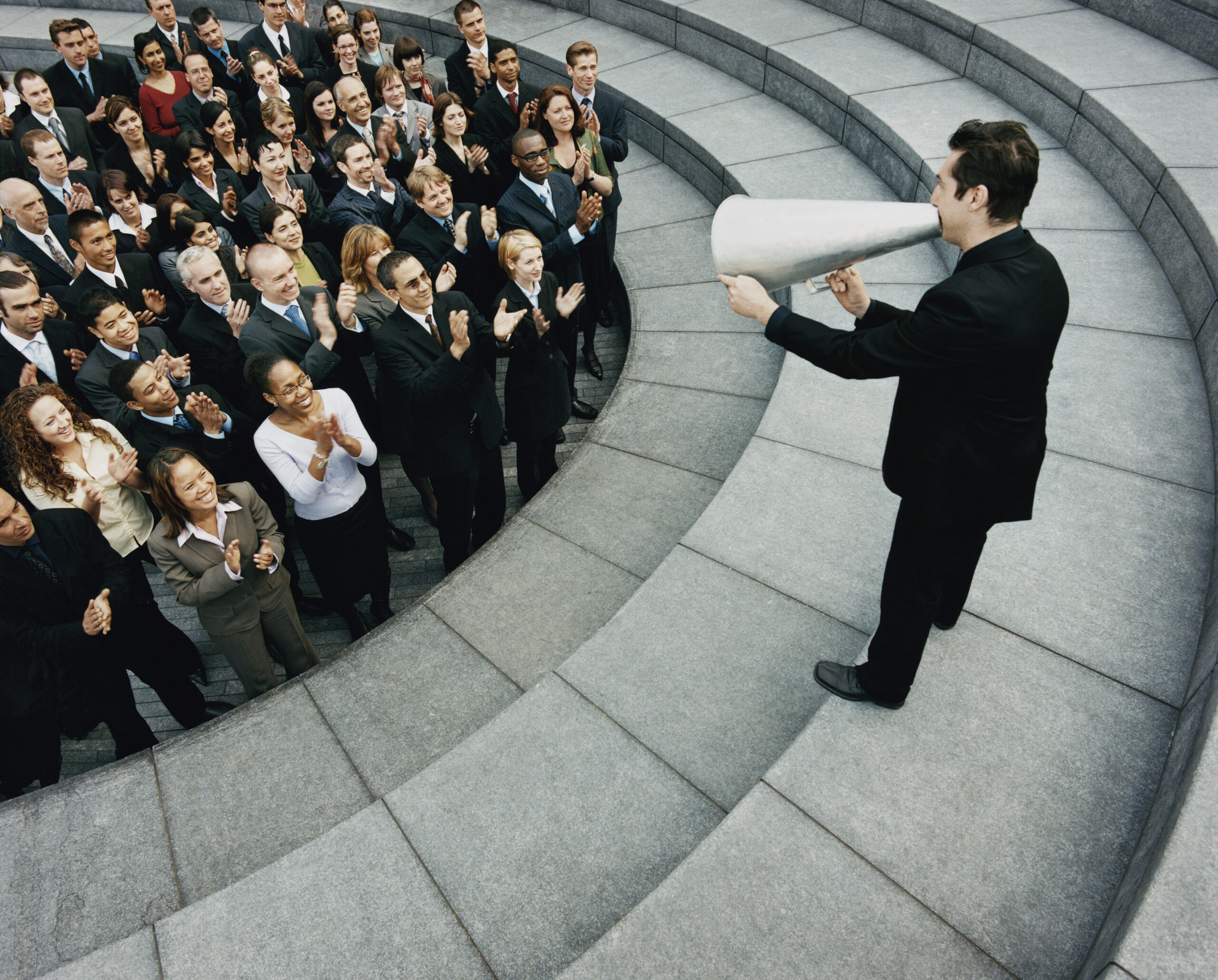 Man with loudhailer addressing staff, existing staff concept