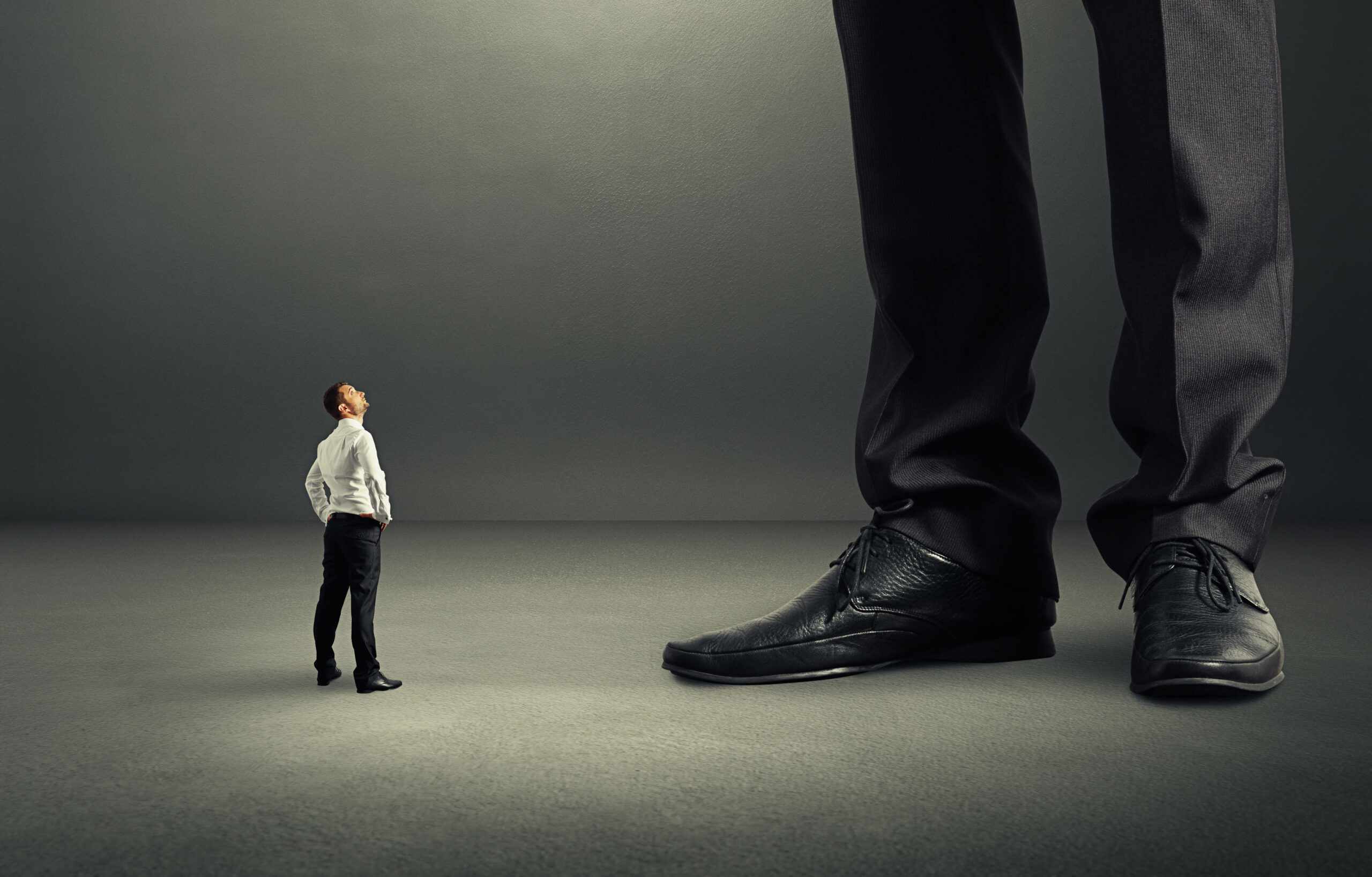 Small businessman looking at his big boss