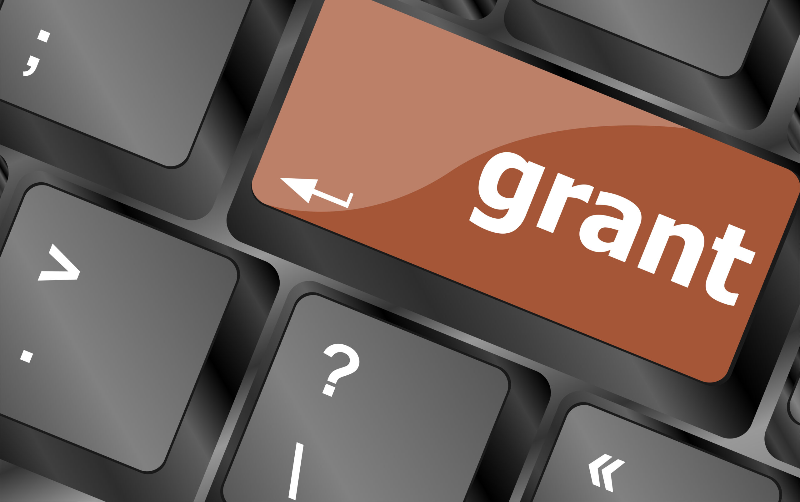 Business grant council concept. Computer keyboard with word Grants where the return key is