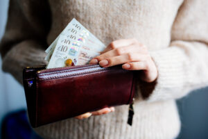 Woman taking cash out of purse
