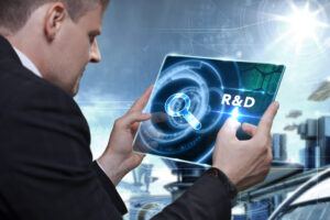 Businessman staring at R&D on tablet