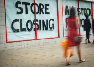 Store Closing sign on shopping high street, coronavirus grant concept