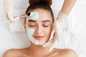 Woman having face mask applied at salon - beautician insurance
