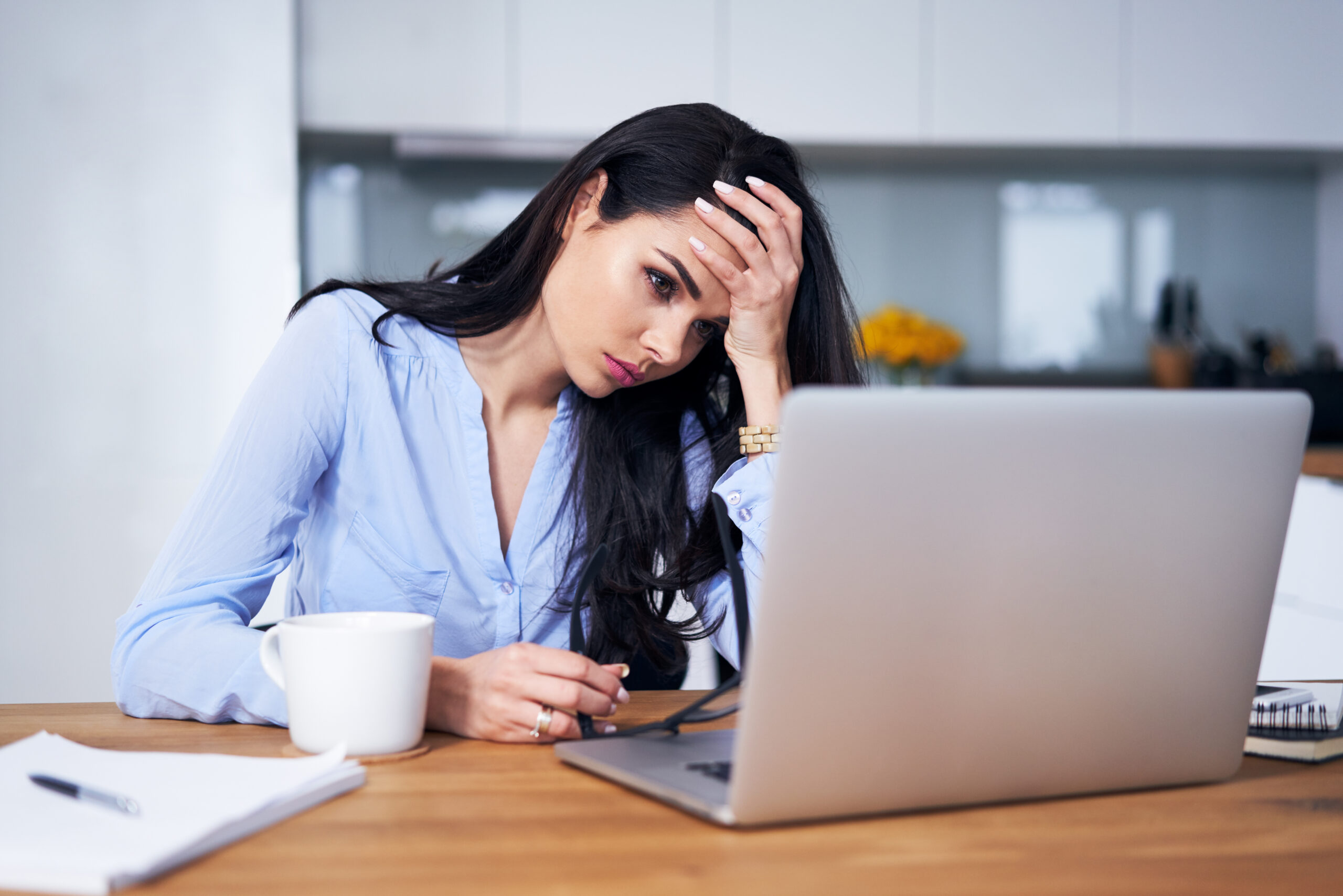 Tired woman working with laptop in home office, personal service company concept