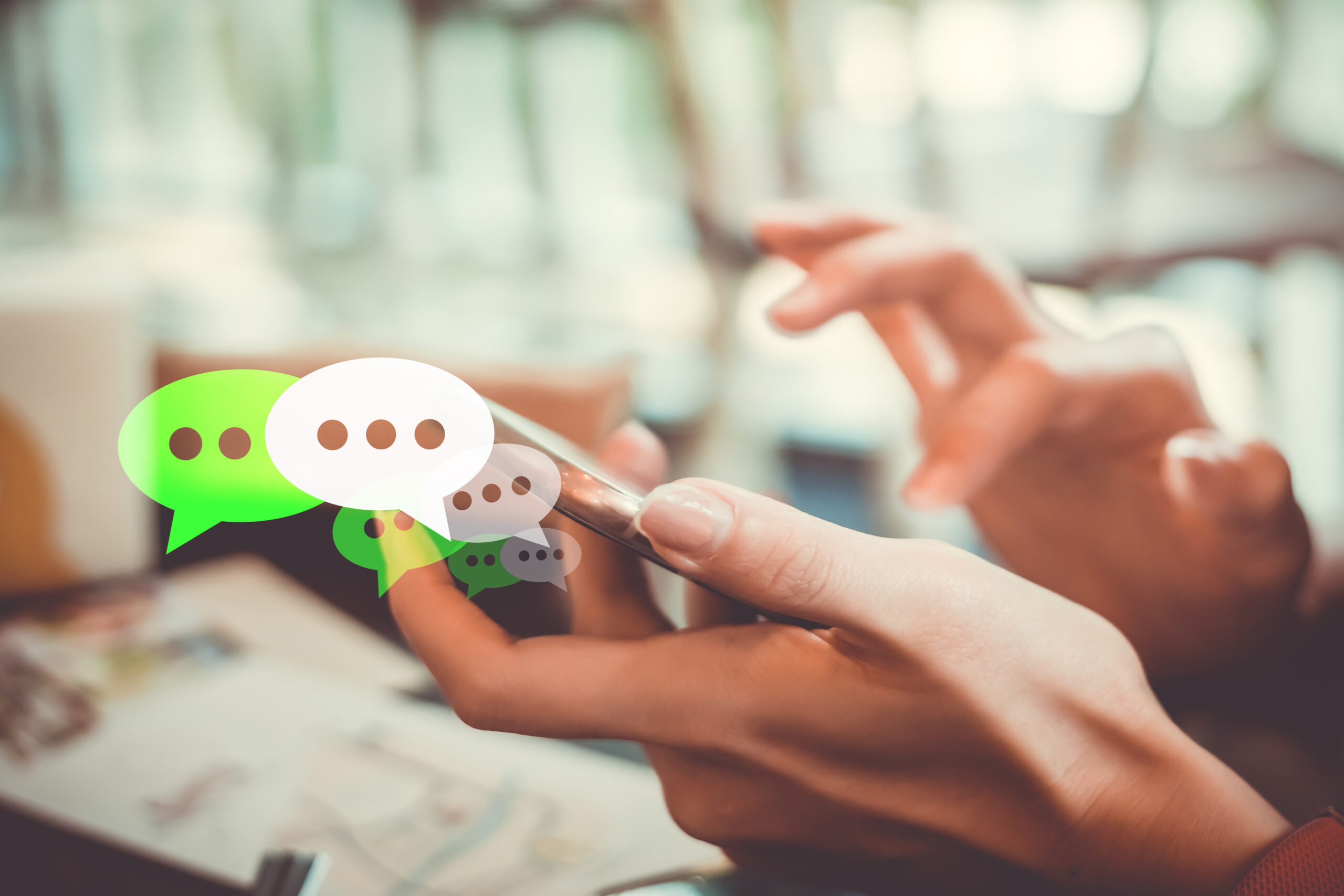 Women hand using smartphone typing, chatting conversation in chat box icons pop up. Live Chat concept