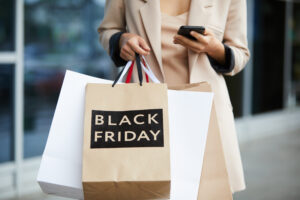 Woman holding shopping bags, maximise product sales Black Friday concept