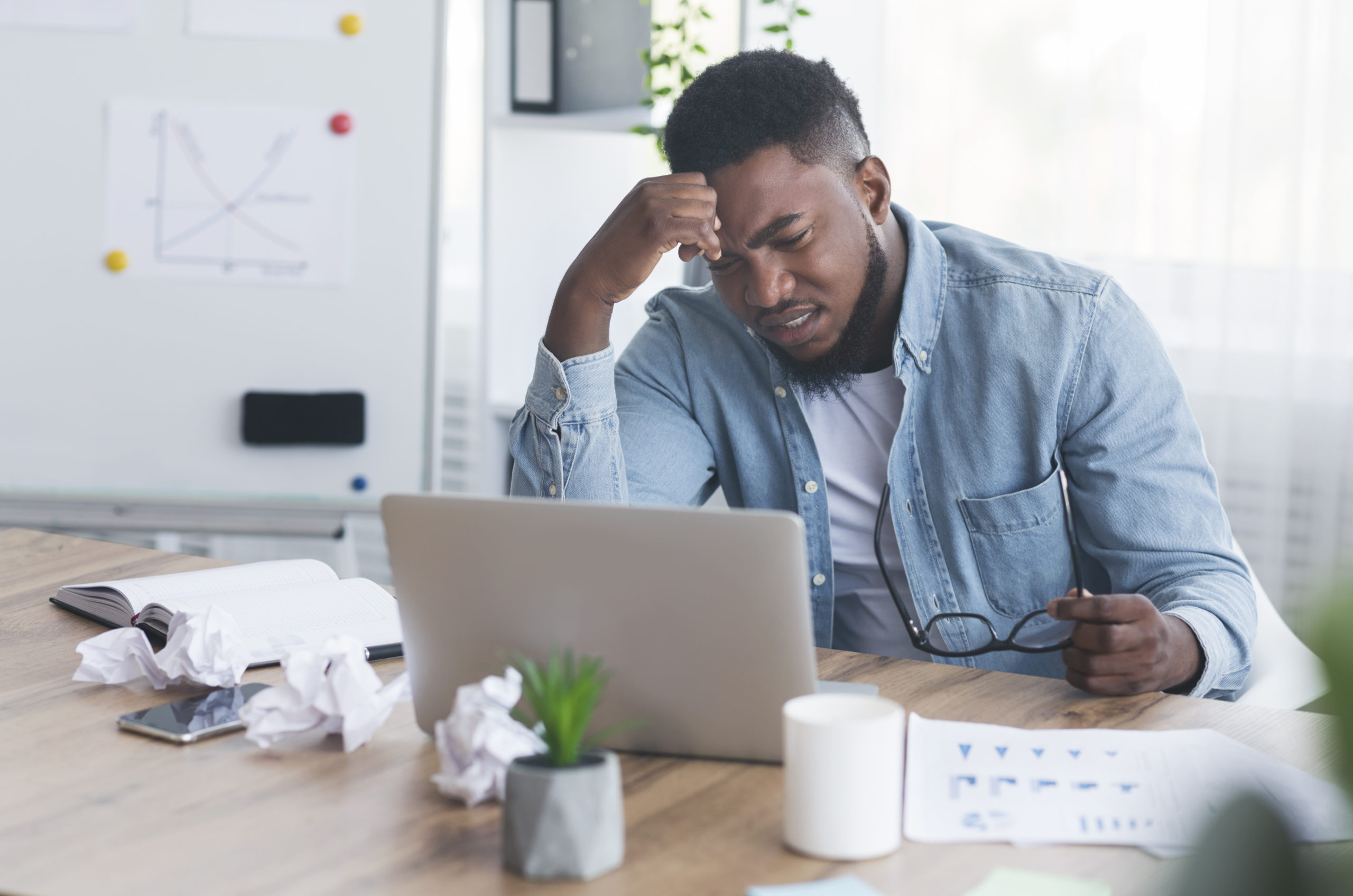 Stressed employee sitting at workplace and looking to laptop screen, Rishi Sunak IR35 concept