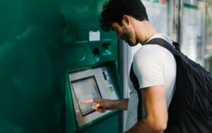 Man buying ticket from kiosk, cashless payments concept