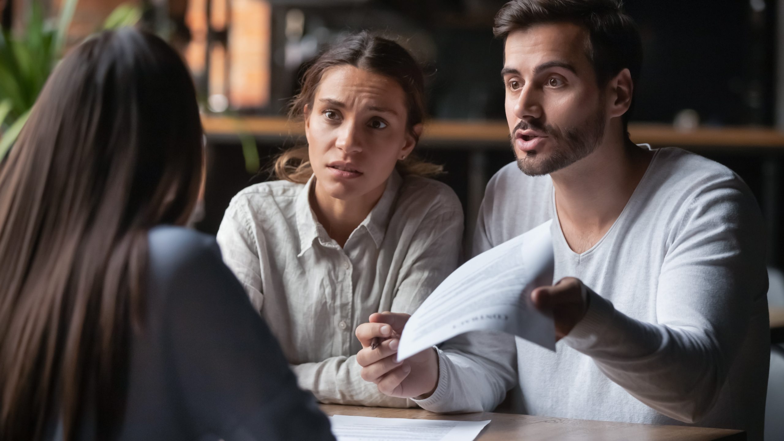 Angry couple confronting bank manager, Business Banking Resolution Service concept
