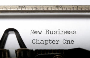Typewriter with words "New Business Chapter One" on sheet of paper. Start a new business concept