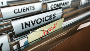 Filing cabinet with unpaid invoices file, chase debts concept