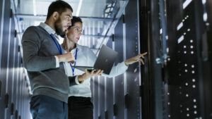 IT workers inspecting server rack, digital adoption concept