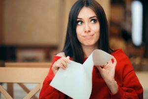 Woman tearing up piece of paper, tearing up Bounce Back Loans concept