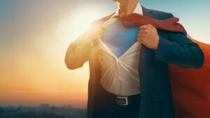 Businessman ripping shirt open in Superman pose, super-deduction concept
