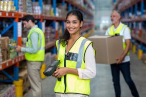 Young woman in hi-vis jacket in warehouse, The Preference Hub concept