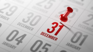 December 31 pinned on paper calendar, small business tax year concept