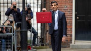 Rishi Sunak standing outside 11 Downing Street holding red box, Autumn Budget small business concept