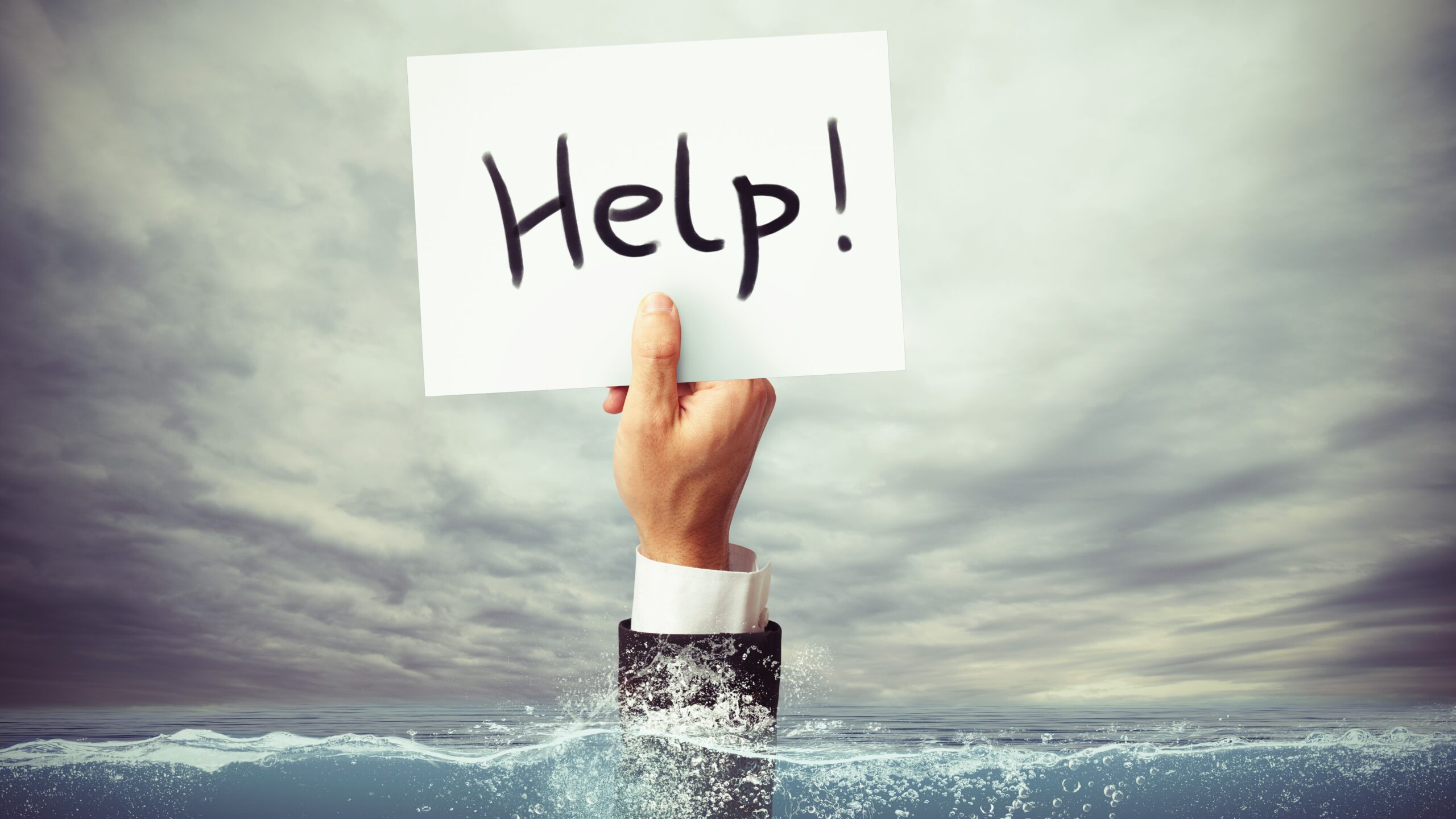 hand rising out of water holding sign saying Help!, toxic debt concept