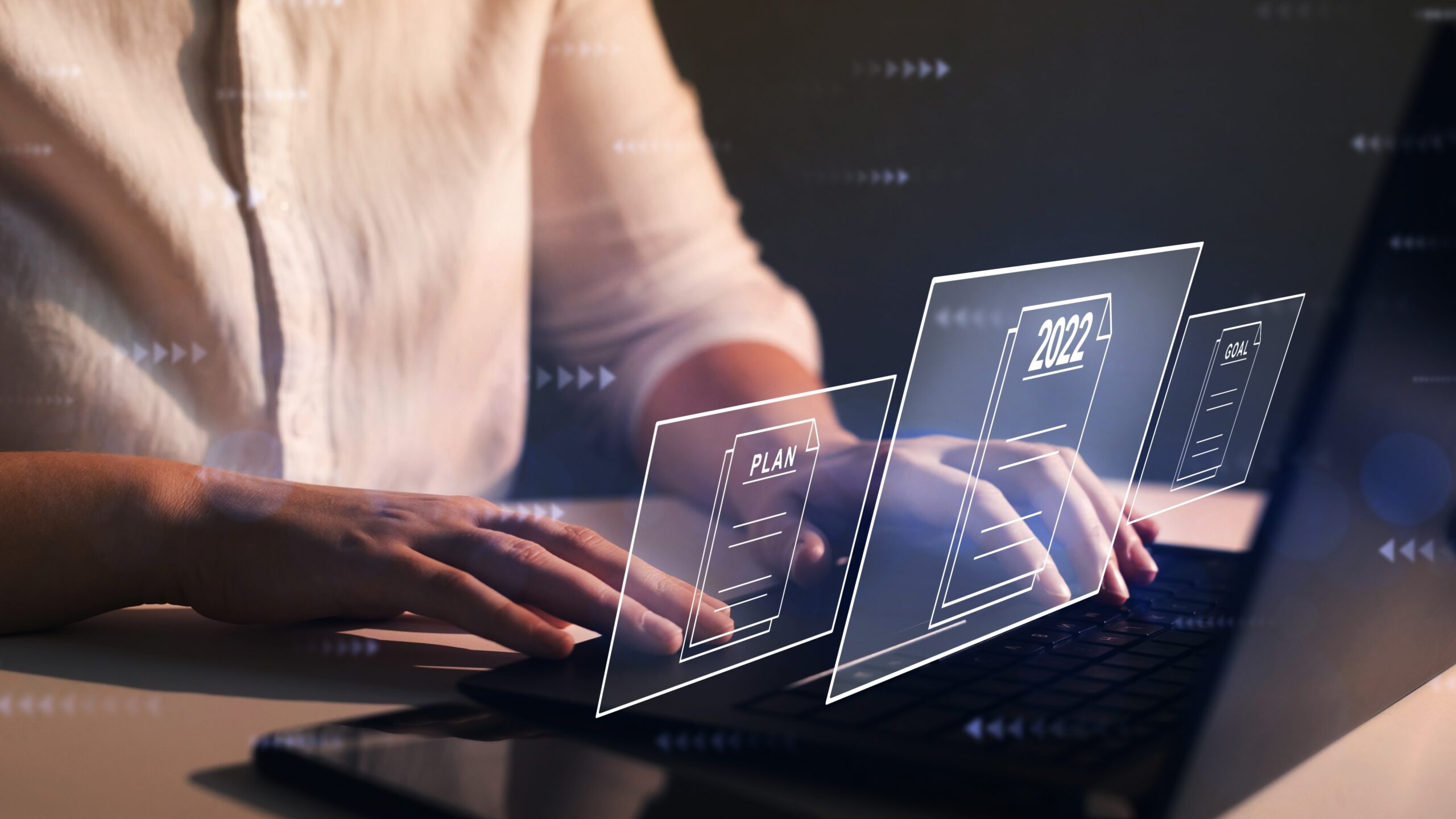 Woman working at laptop with virtual 2022 computer screen, Making Tax Digital 2022 concept