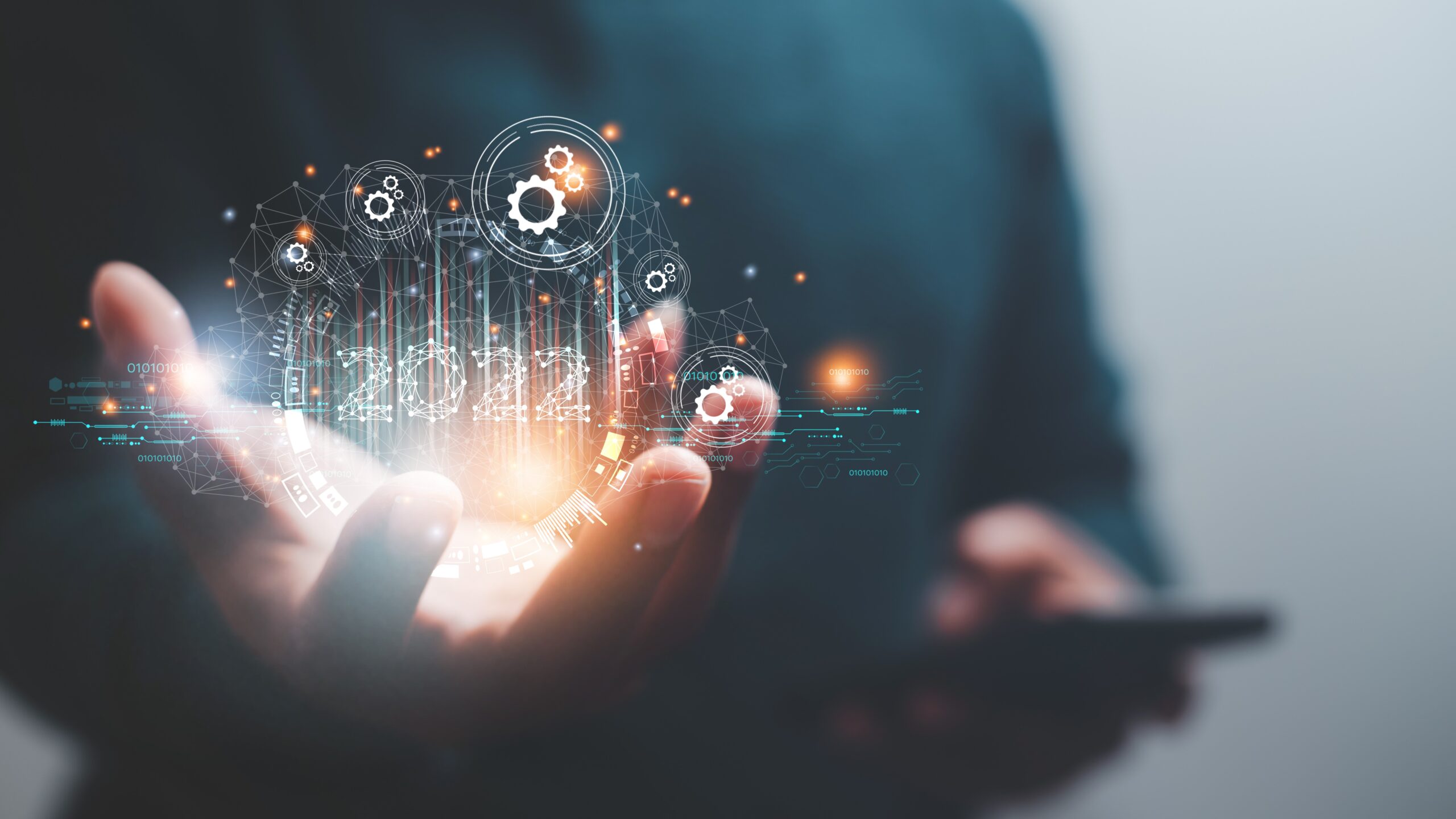 Man holding 2022 snazzy computer graphics in palm of hand, social media 2022 concept