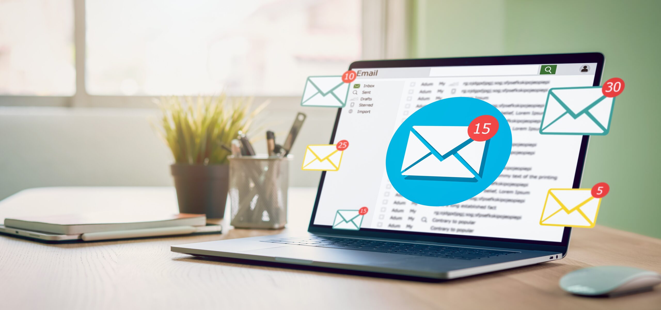 Laptop on desk with email icons floating from it