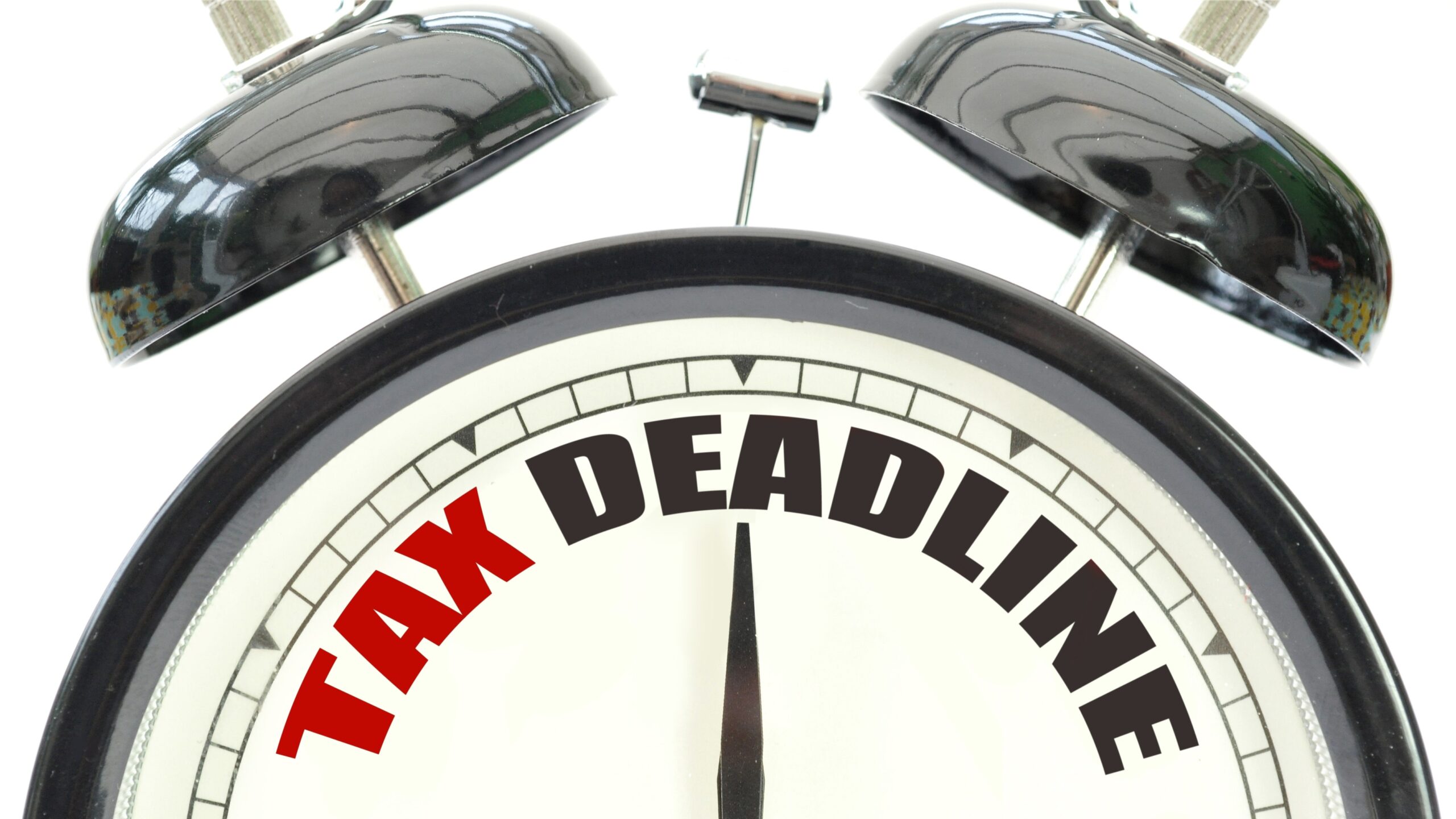 Old-fashioned alarm clock with words tax deadline