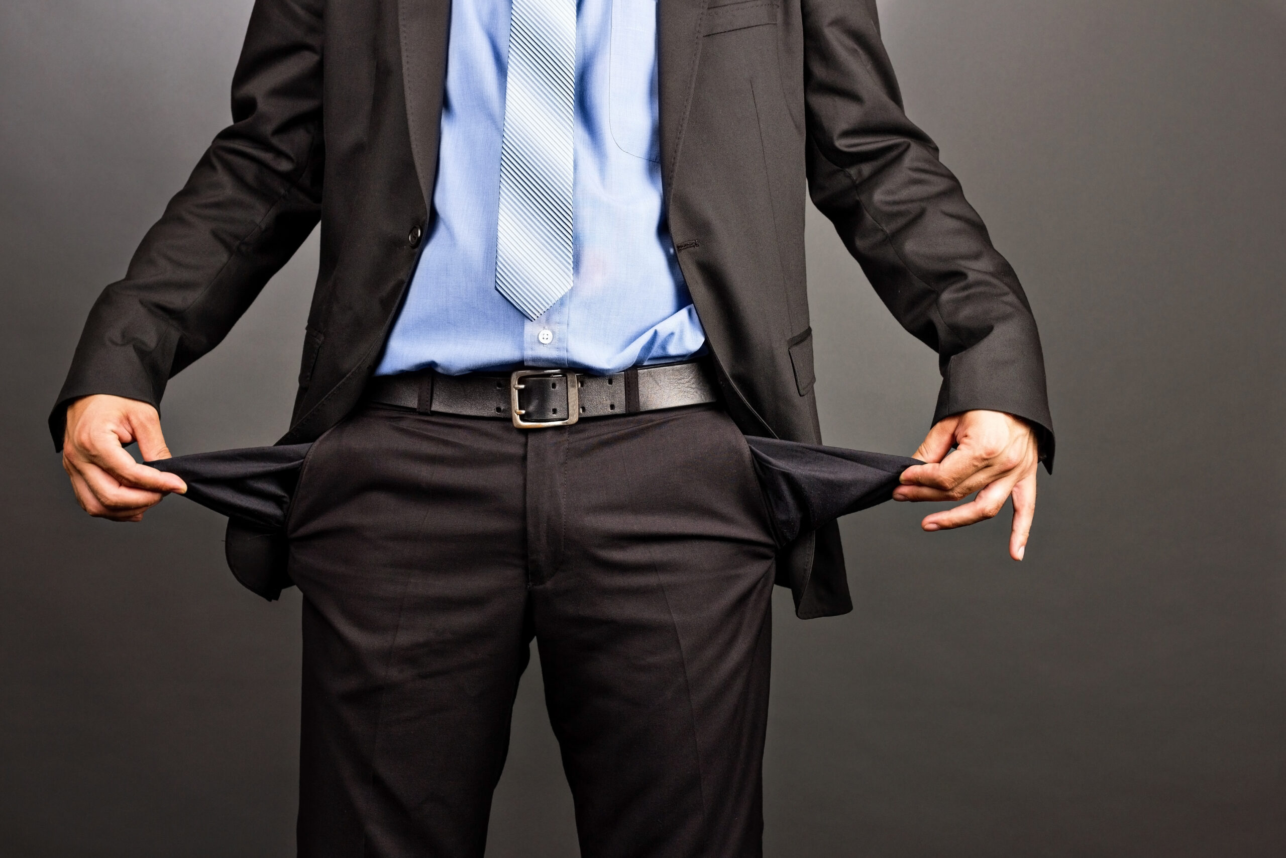 Businessman showing empty pockets x loses cash concept