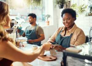 Credit card, payment and shopping with black woman in coffee shop for retail, restaurant and food service. Finance, store and purchase with hands of customer in cafe for spending, consumer and sales
