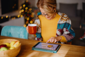 Woman using digital tablet for online Christmas shopping